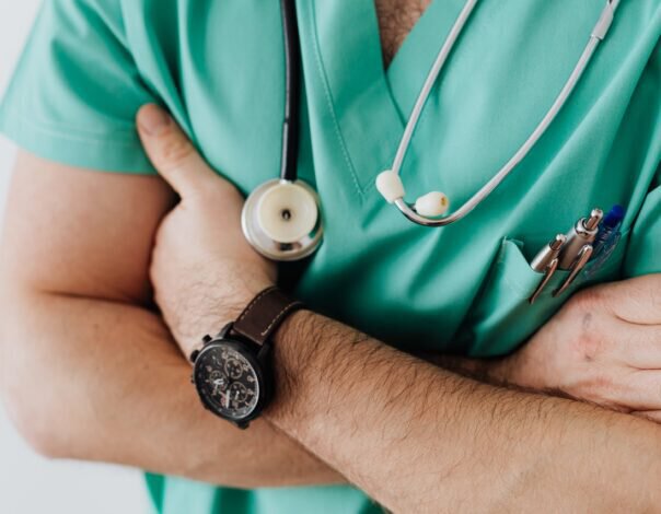 doctor with arms crossed wearing a watch