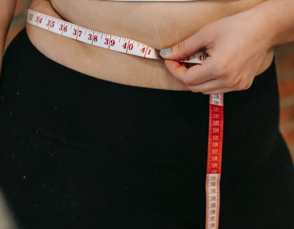 woman measuring waist