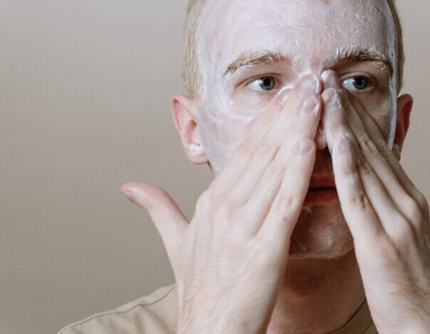 man washing face