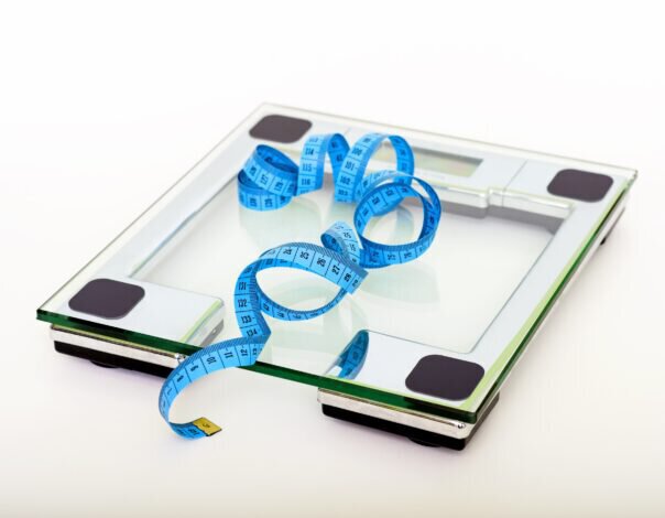 glass weight scale with blue measuring tape